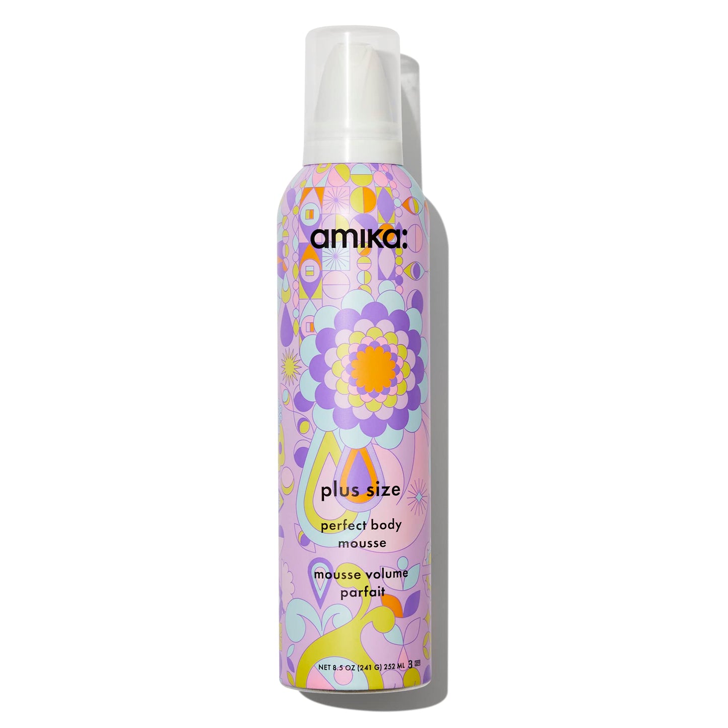 Amika mousse bottle with colorful floral design on a white background