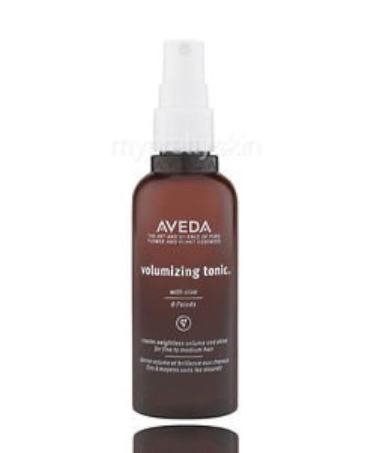 Aveda volumizing tonic bottle on a white background