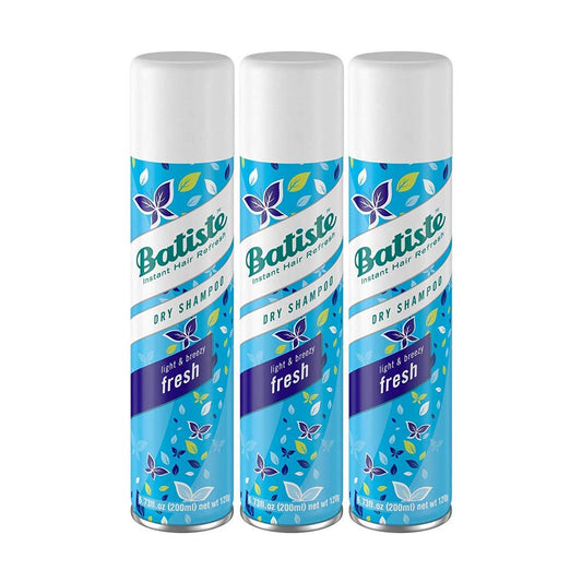 Three bottles of Batiste dry shampoo on a white background