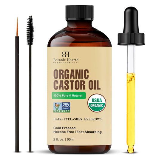 Organic castor oil bottle with dropper, brush, and label on a white background
